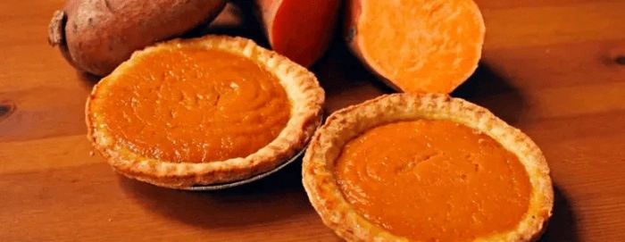 Golden pumpkin pie on rustic wooden surface